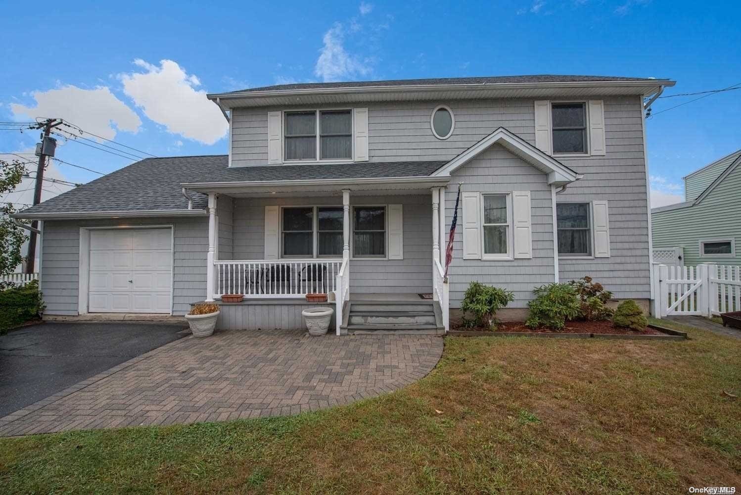 433 West Main Street Babylon, NY 11702 - Photo 1 of 1 front view of a house with a yard