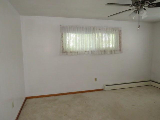 120 Virginia Street Latrobe, PA 15650 - Photo 13 of 31 an empty room with a window and a ceiling fan