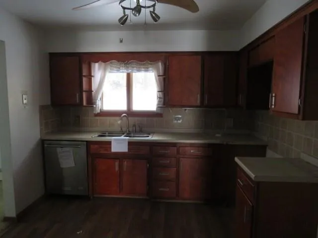 a kitchen with a refrigerator and a stove top oven