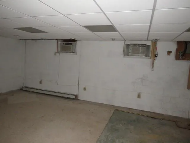a view of empty room with kitchen