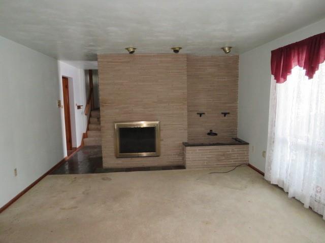 120 Virginia Street Latrobe, PA 15650 - Photo 5 of 31 a view of an empty room with a fireplace and window