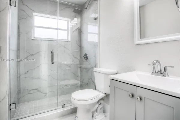 a bathroom with a sink toilet and shower