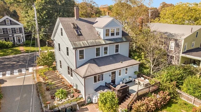 an aerial view of a house with a yard