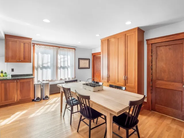 a kitchen with stainless steel appliances granite countertop wooden floor sink stove and a granite counter top
