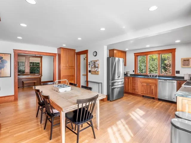 a view of a a dining room with furniture window and wooden floor