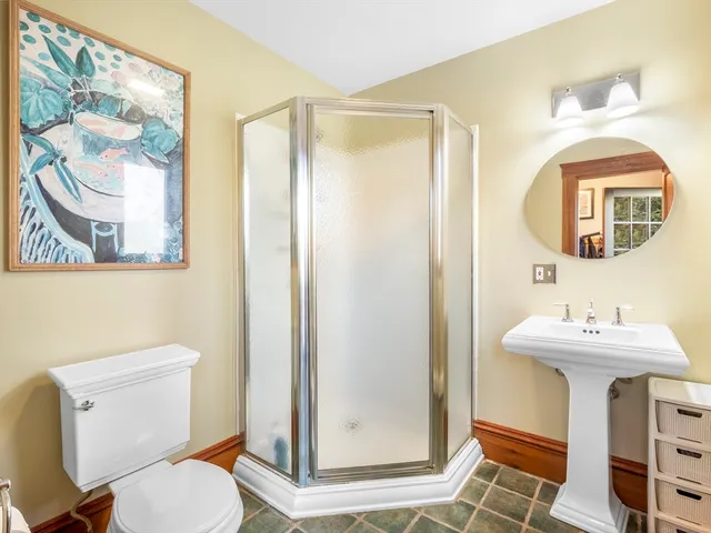 a view of a hallway with wooden floor and stairs