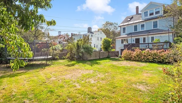 a view of a house with backyard and sitting area