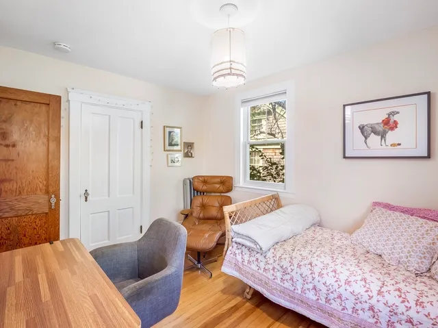 a bedroom with furniture and a window