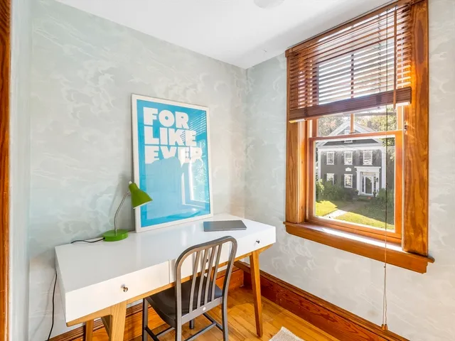 a bedroom with bed and a wooden floor