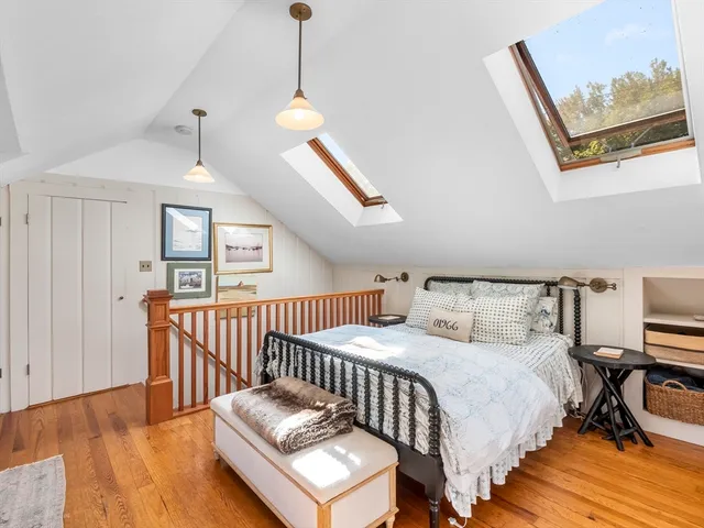 a living room with a bed furniture and next to a window