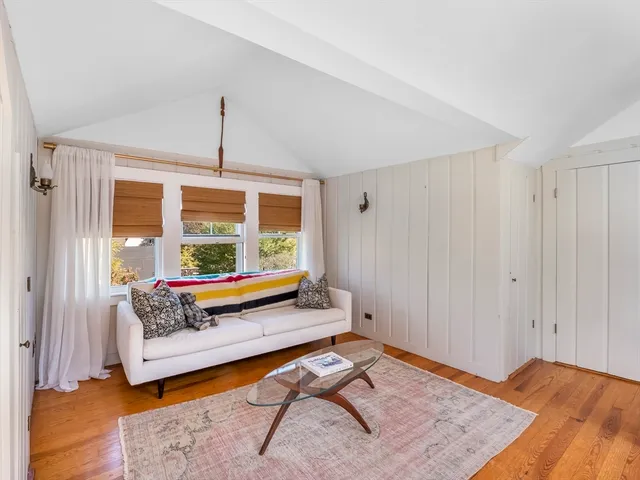 a bedroom with furniture and wooden floor