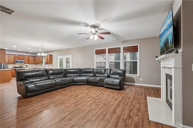 a kitchen with a sink a counter top space stainless steel appliances cabinets and a large window