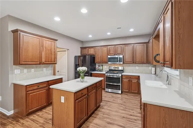 a spacious bedroom with a bed a couch and a computer on a desk