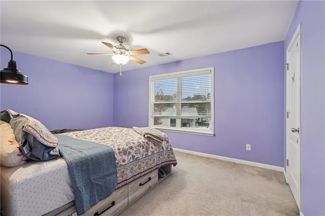 an aerial view of a house with a yard and a large tree