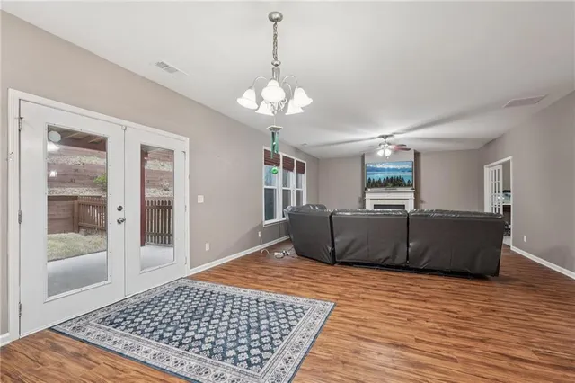 a kitchen with stainless steel appliances granite countertop a sink cabinets and wooden floor
