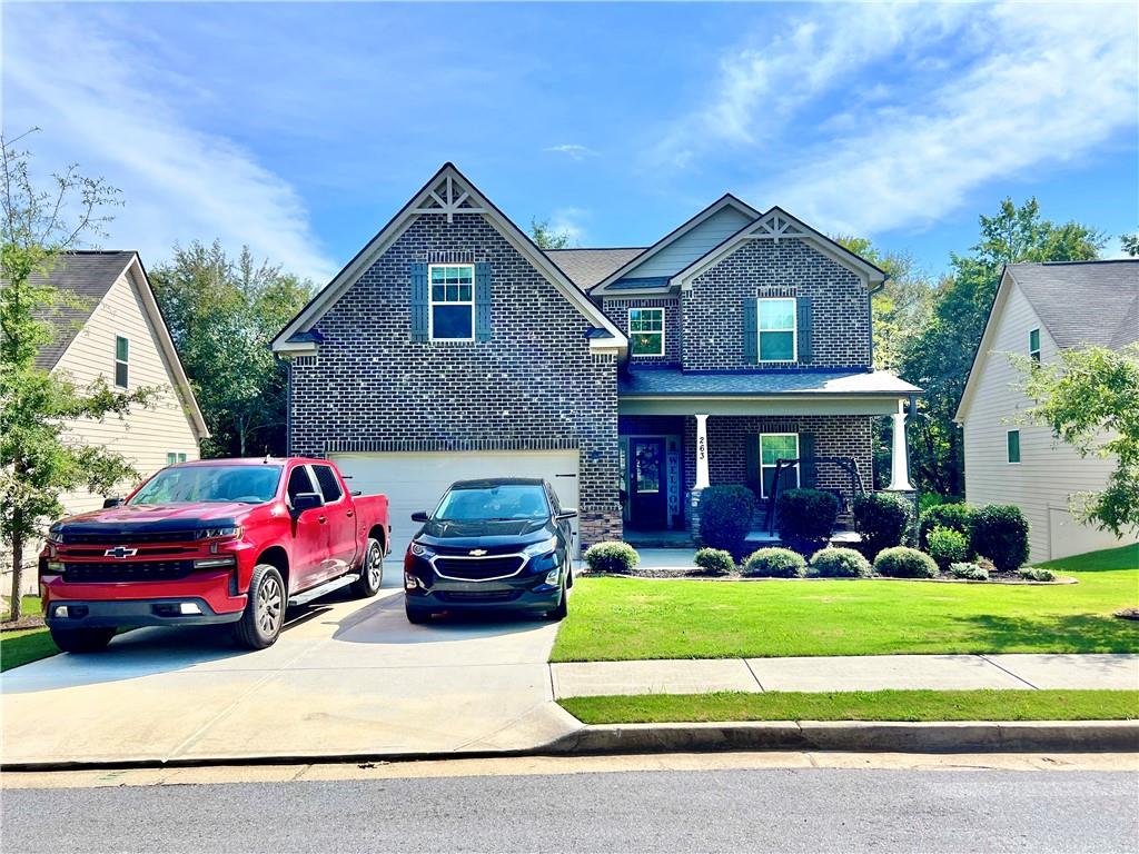 a front view of a house with a yard