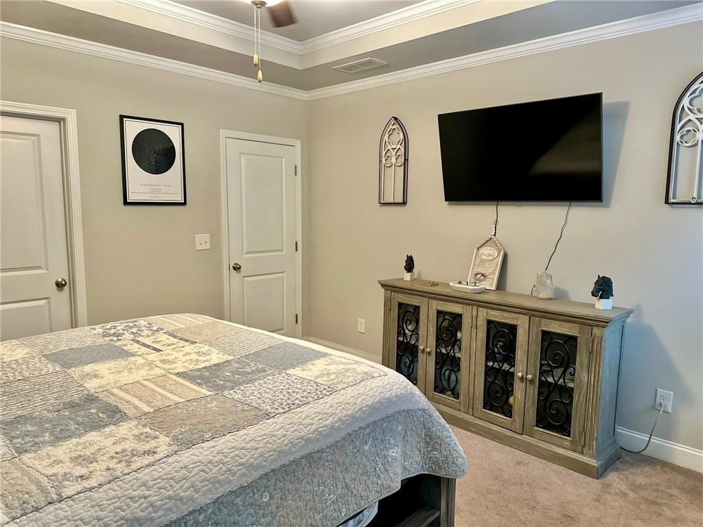 263 Camden Lake Drive Villa Rica, GA 30180 - Photo 12 of 25 a spacious bedroom with a bed and a flat screen tv