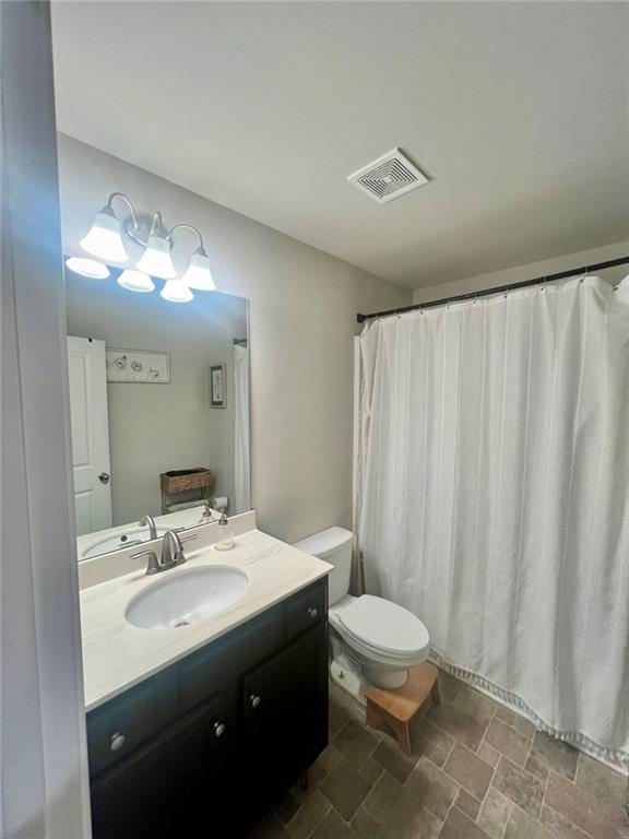 263 Camden Lake Drive Villa Rica, GA 30180 - Photo 19 of 25 a bathroom with a double vanity sink toilet and a mirror