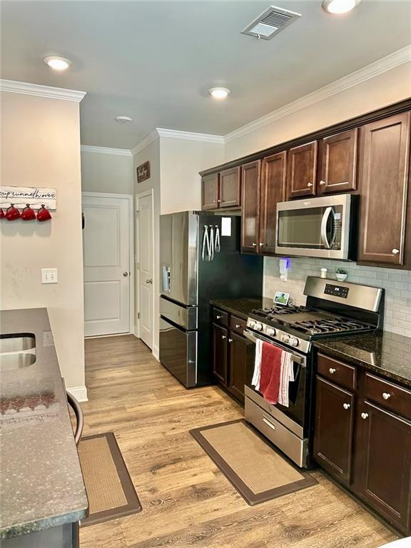 263 Camden Lake Drive Villa Rica, GA 30180 - Photo 10 of 25 a kitchen with stainless steel appliances granite countertop a refrigerator stove and oven
