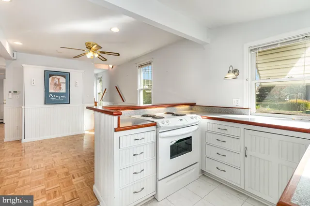 a view of a kitchen with stove and cabinets