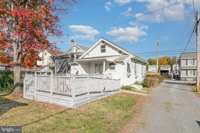 a view of a house with wooden fence