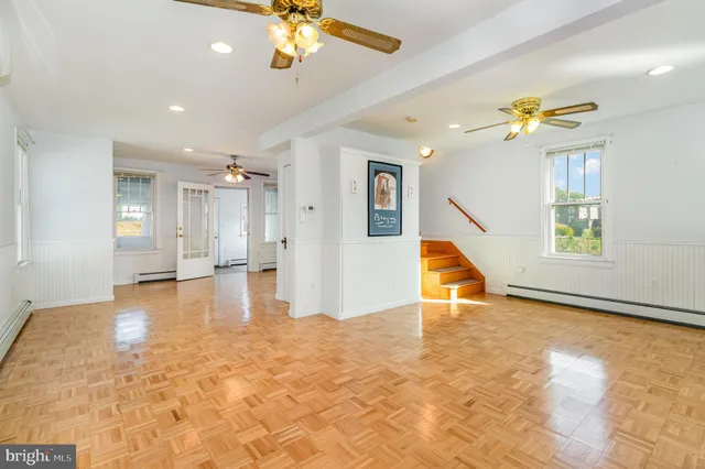 a view of a livingroom with a ceiling fan and window