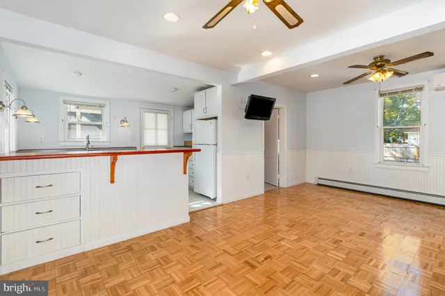 a view of a kitchen with cabinet and a chandelier fan