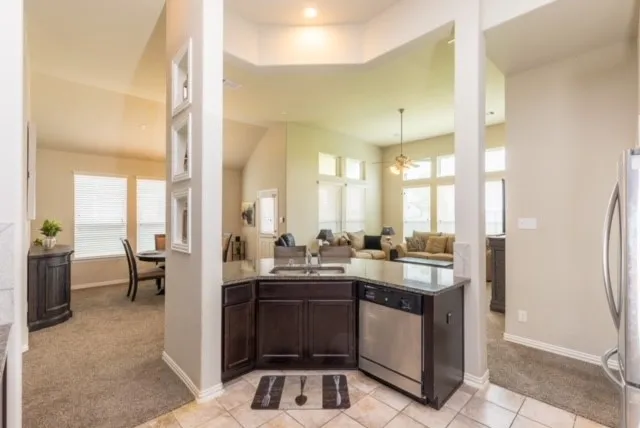 a bathroom with a granite countertop sink a toilet and shower