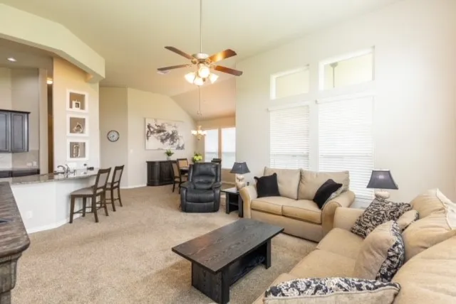 a kitchen with kitchen island granite countertop a sink cabinets and stainless steel appliances