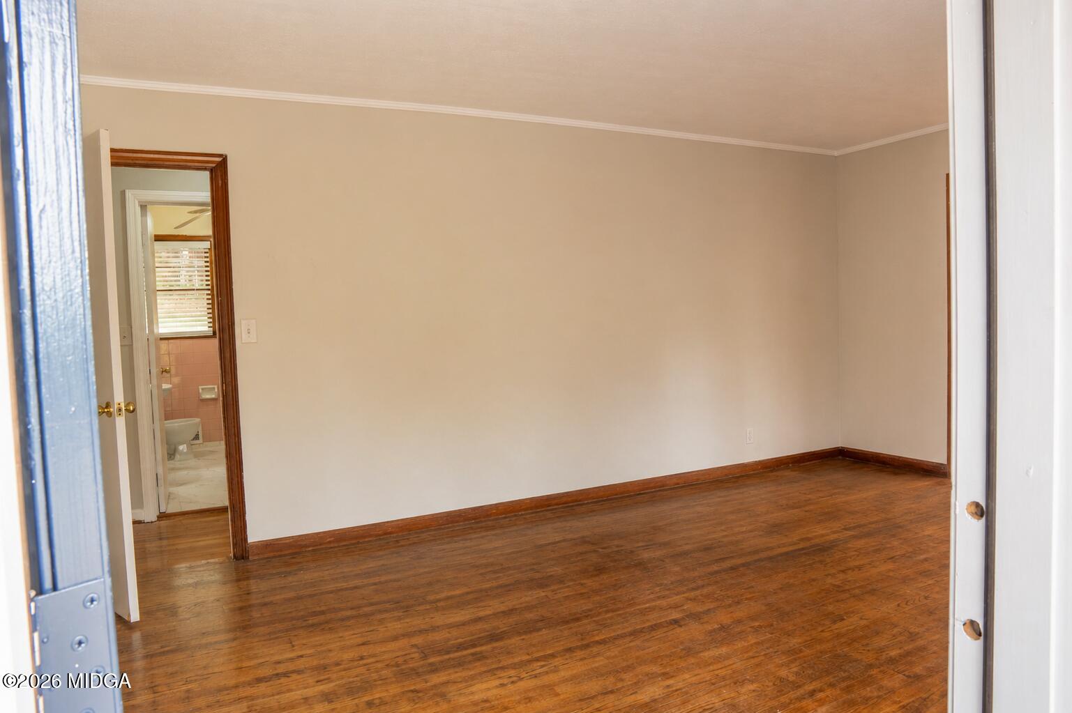 3319 Mohawk Road Macon, GA 31217 - Photo 13 of 38 a view of an empty room with wooden floor and a window