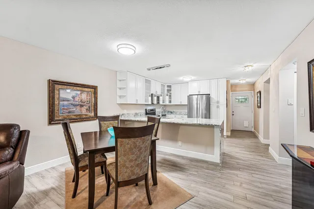 a view of a dining room with furniture and wooden floor