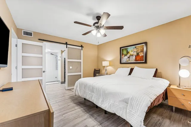 a bedroom with a bed and a chandelier