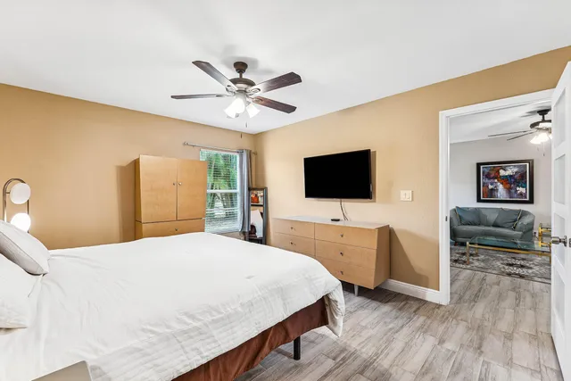 a bedroom with a bed and a flat screen tv