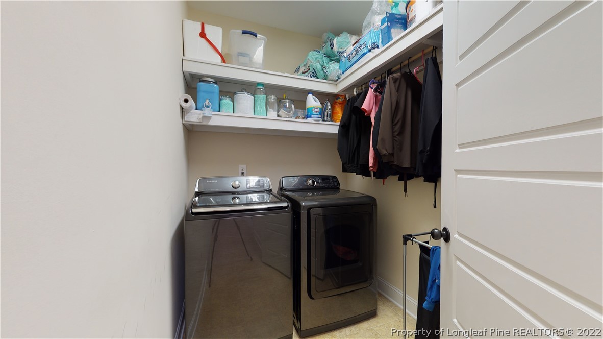 109 Caulfield Road Aberdeen, NC 28315 - Photo 12 of 28 a view of walk in closet with clothes and shoes