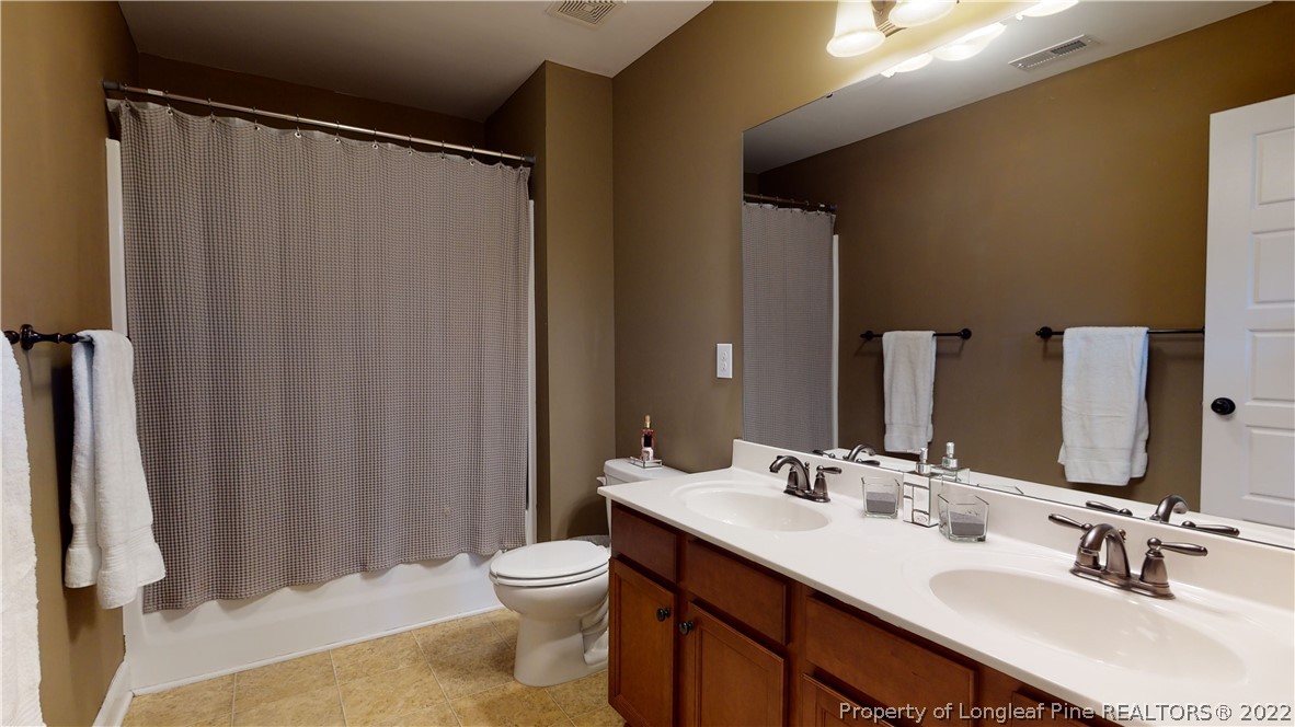 109 Caulfield Road Aberdeen, NC 28315 - Photo 20 of 28 a bathroom with a sink mirror and a toilet