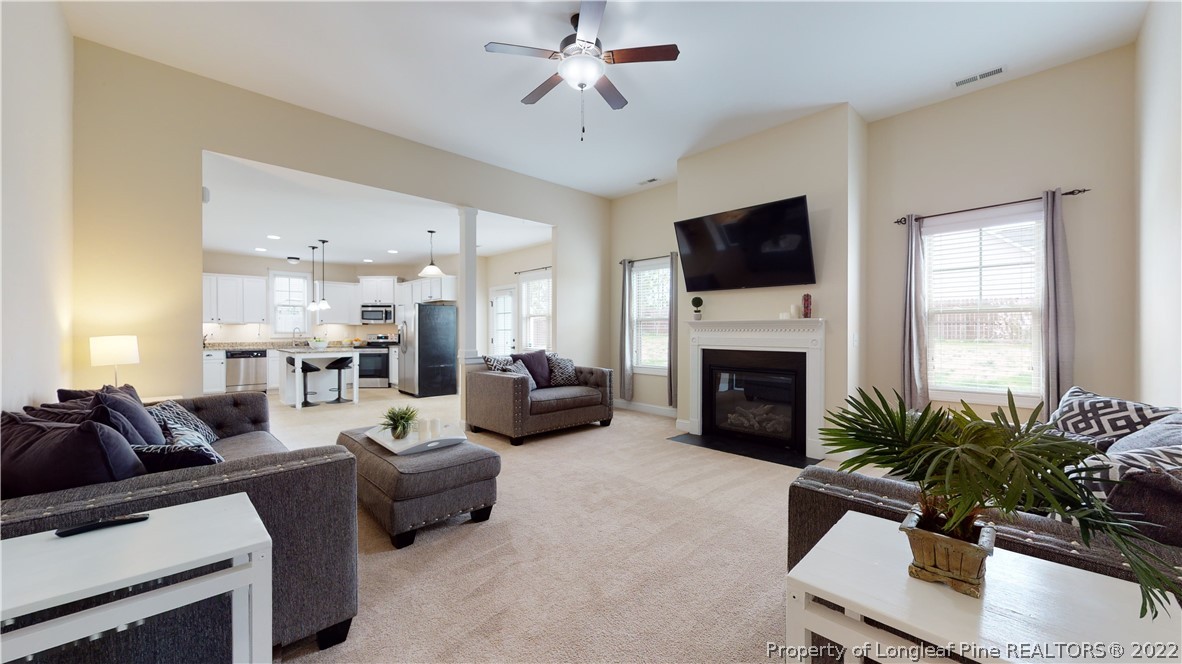 109 Caulfield Road Aberdeen, NC 28315 - Photo 5 of 28 a living room with furniture a fireplace and a flat screen tv