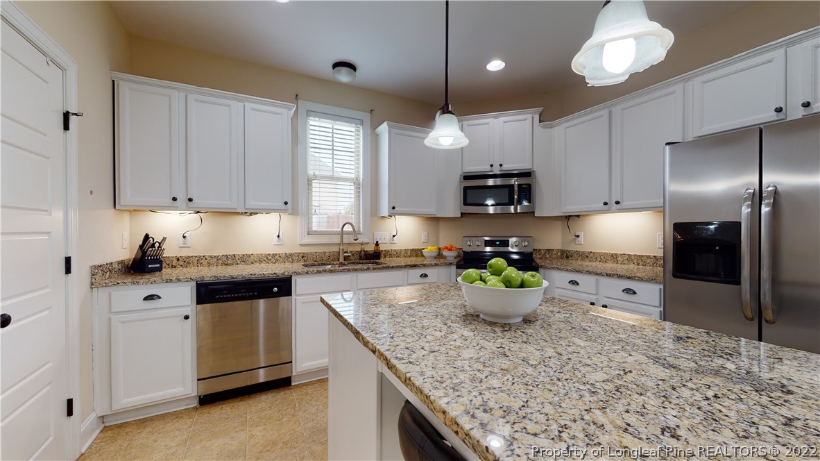 109 Caulfield Road Aberdeen, NC 28315 - Photo 9 of 28 a kitchen with a stove a sink and a refrigerator