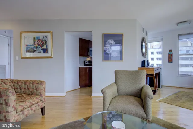 a living room with furniture and painting on the wall