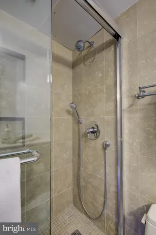 a bathroom with a glass shower door