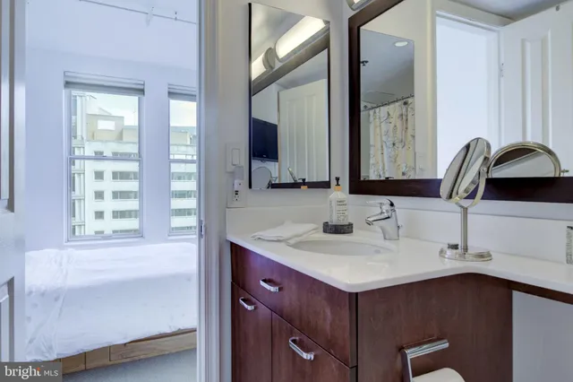 a bathroom with a sink vanity and a mirror