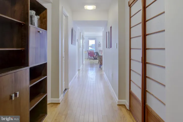 a view of a hallway with wooden floor and entryway