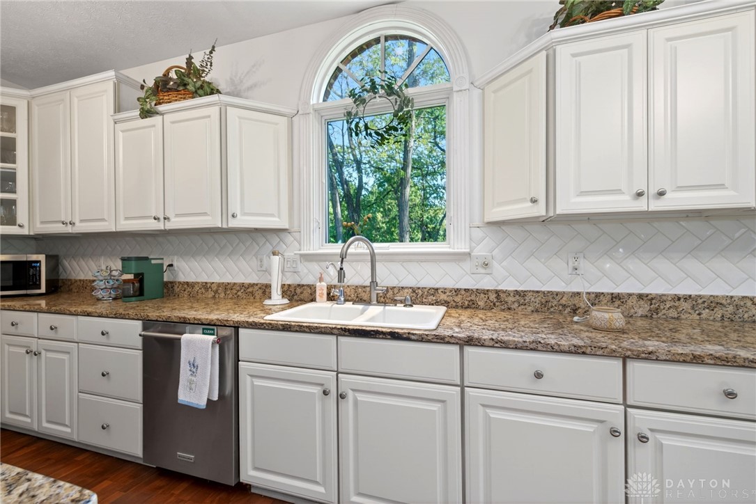 330 South Alpha Bellbrook Road Bellbrook, OH 45305 - Photo 29 of 87 This bright kitchen features ample cabinetry and a serene view of the outdoors.