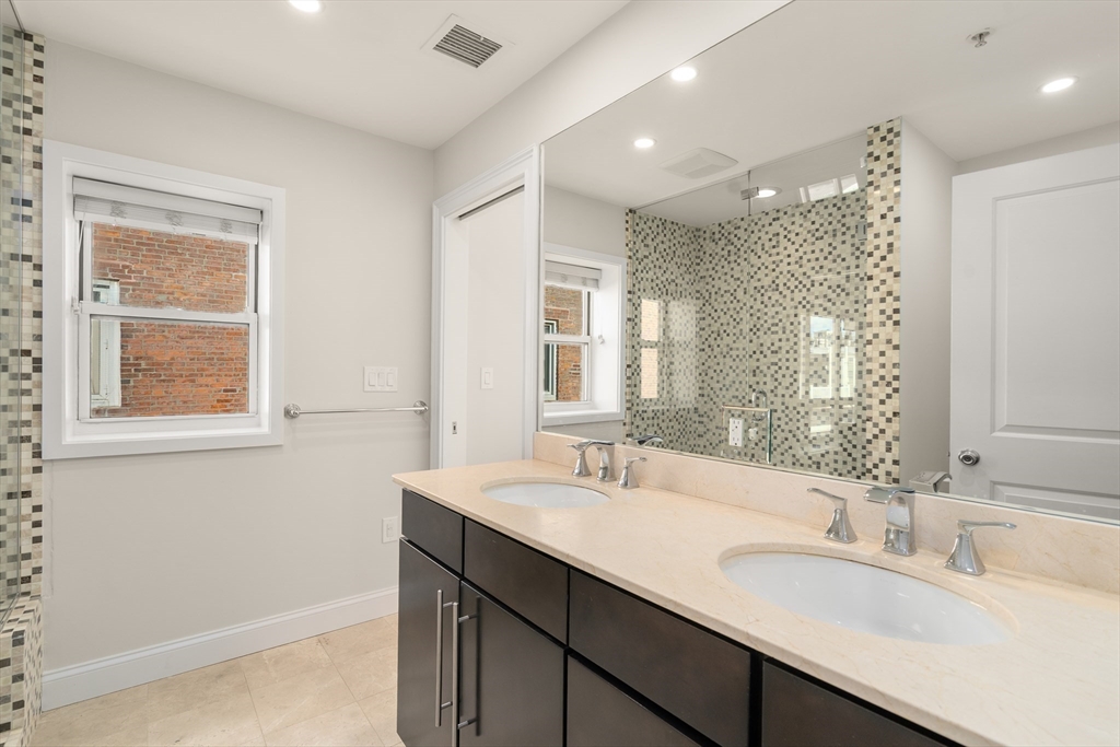 9 North Margin Street Boston, MA 02113 - Photo 7 of 12 a bathroom with double vanity sinks and a mirror