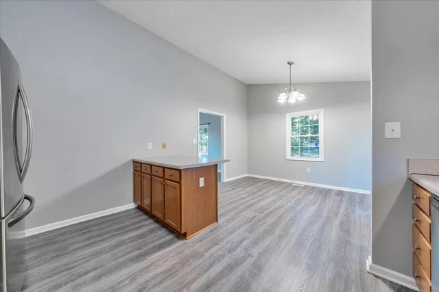 an empty room with windows and wooden floor