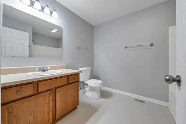 a bathroom with a sink a toilet and a mirror