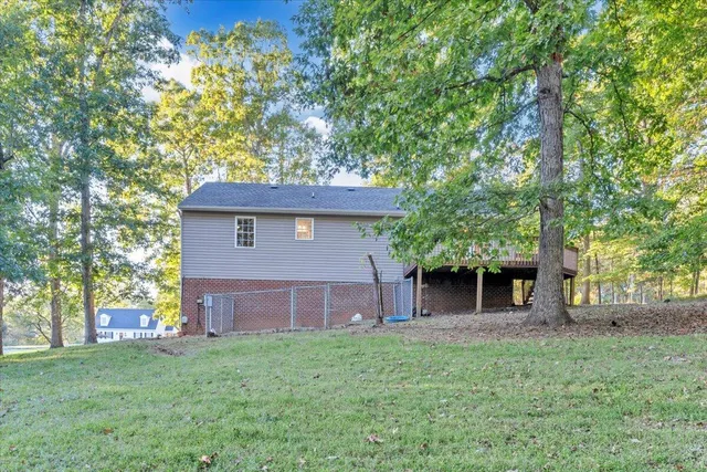 a view of a house with a yard and tree