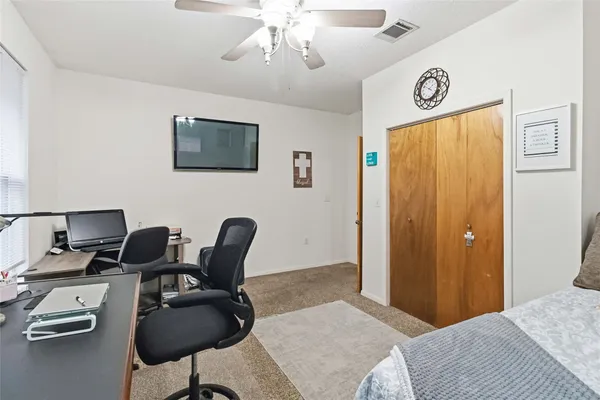 a bedroom with furniture and a window