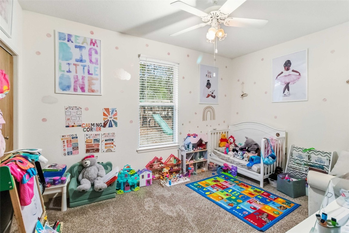 581 State Highway 95 Elgin, TX 78621 - Photo 12 of 30 a play room with toys and a book shelf