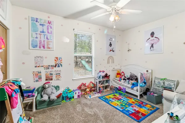 a play room with toys and a book shelf