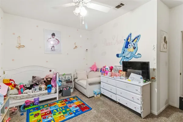a bedroom with furniture a couch and a baby crib